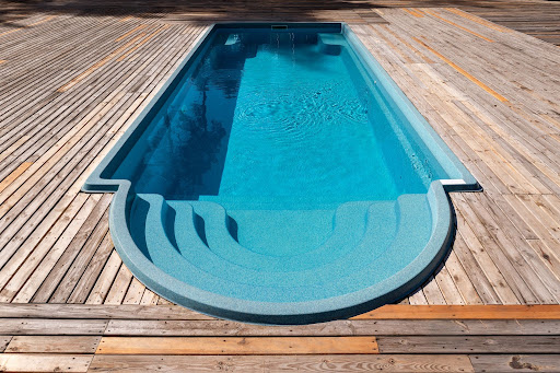 fiberglass pool surrounded by wooden deck
