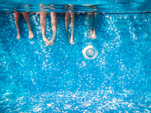 underwater shot of swimmers dangling legs inside pool